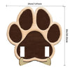 A wooden paw print cutout used as a frame for a photo, featuring a dark brown color.