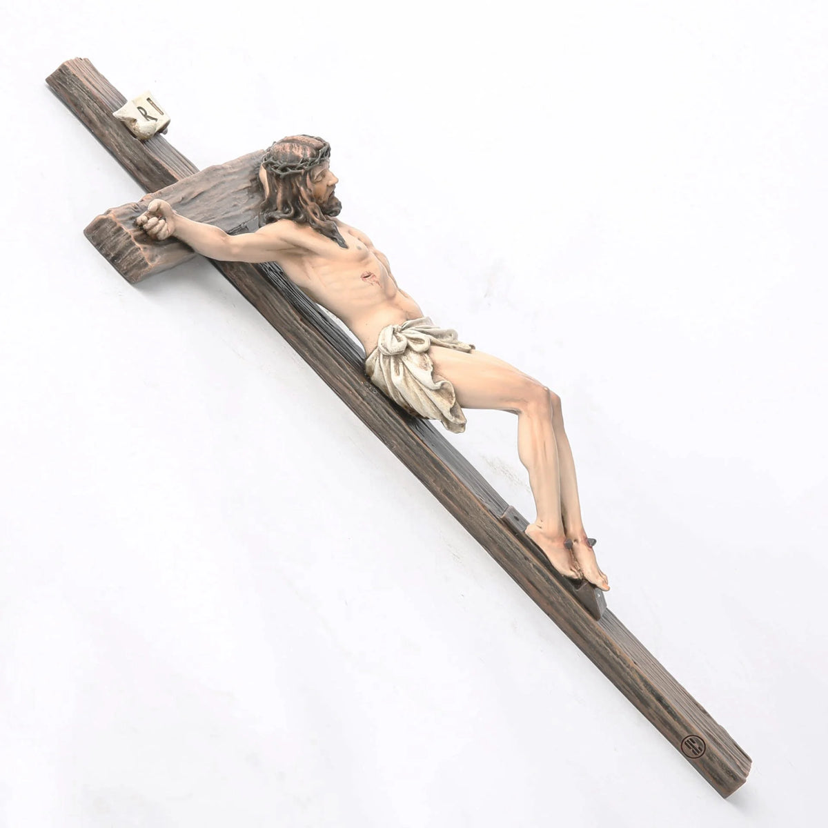 A resin figurine depicting Jesus on a wooden cross for home and office decor.