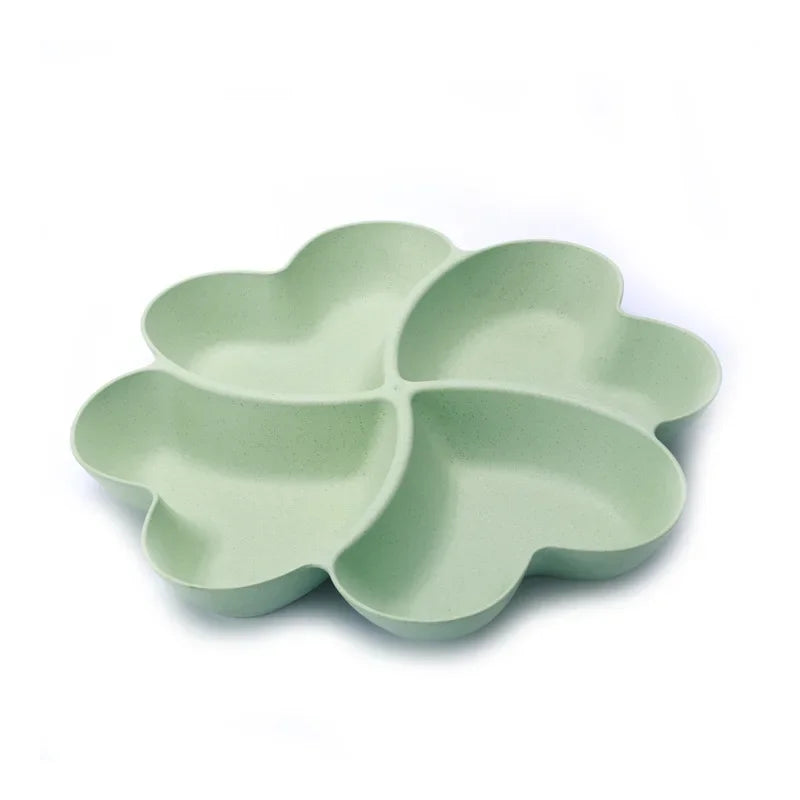 A light green heart-shaped four-compartment snack tray.