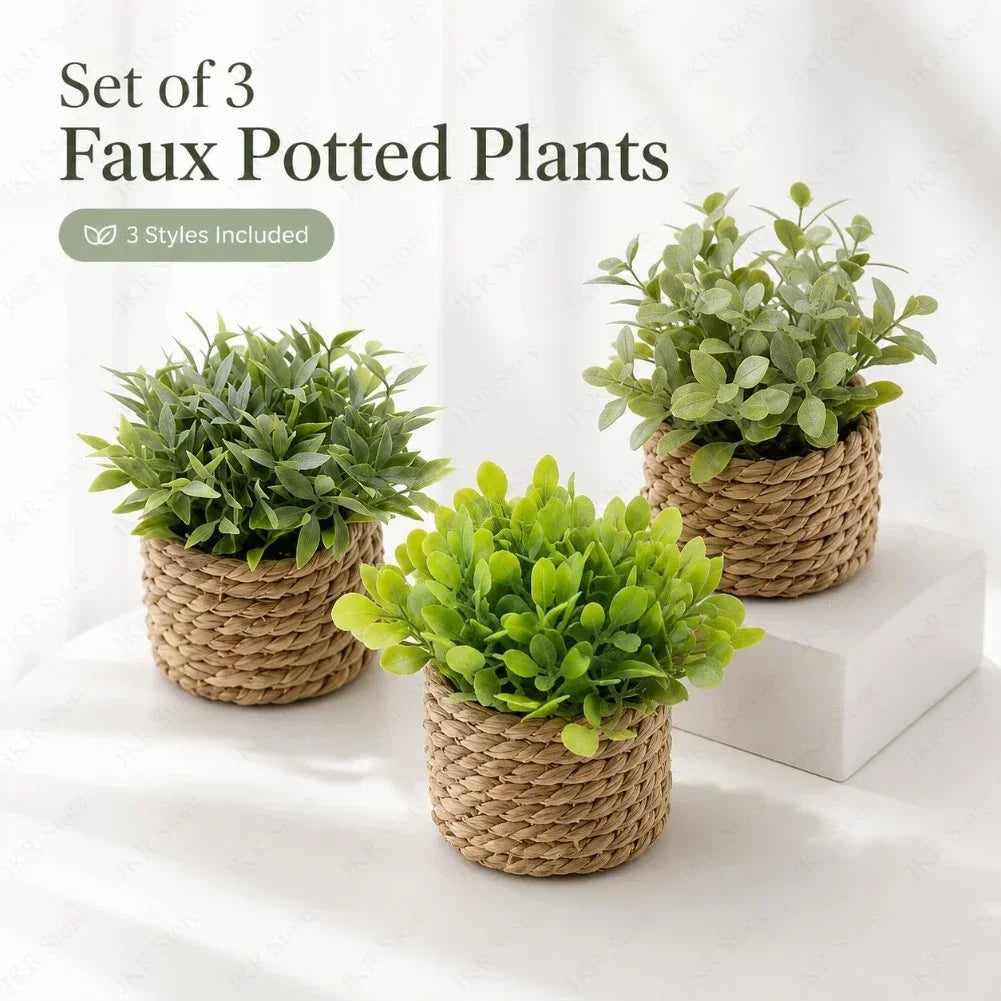 Set of three faux potted plants in woven baskets displayed on a white surface.