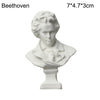 White plaster bust miniature of Beethoven on a pedestal.