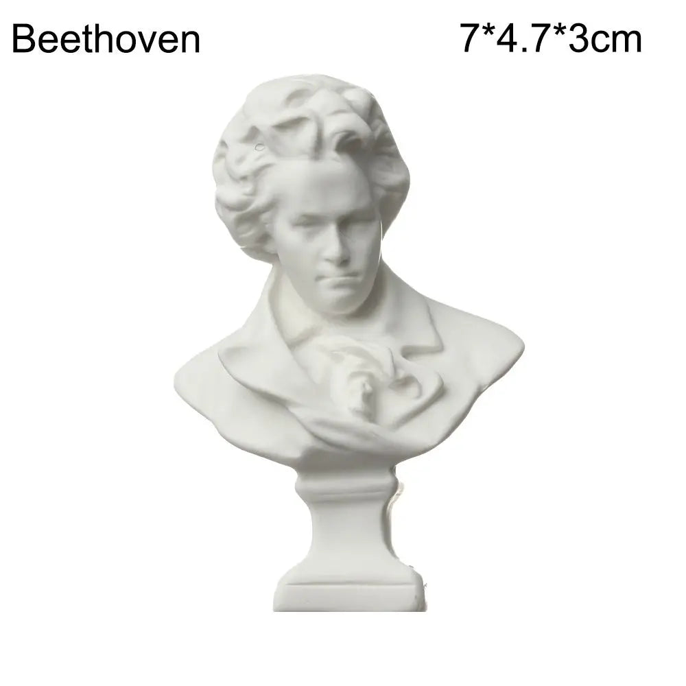 White plaster bust miniature of Beethoven on a pedestal.