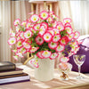 A bouquet of artificial silk cloth flowers in shades of pink and white displayed on a table.