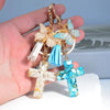 Gold and blue resin cross butterfly keychain with white tassel charms