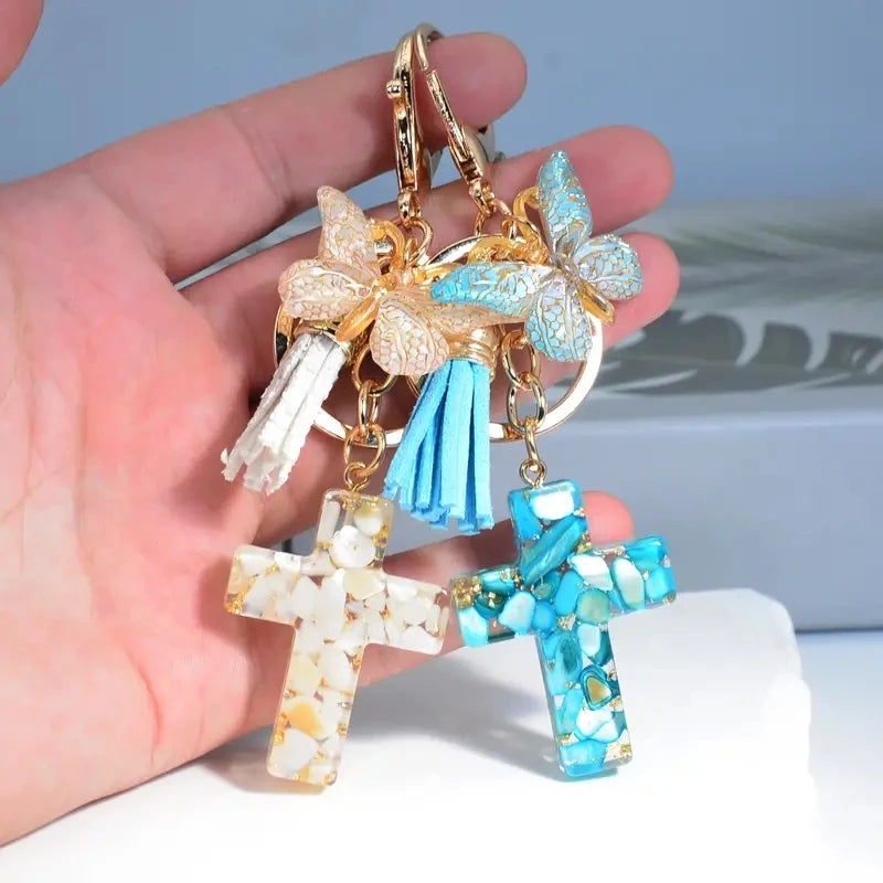 Gold and blue resin cross butterfly keychain with white tassel charms