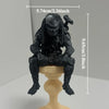 A dark sci-fi figurine of an interstellar hunter seated on a pedestal, measuring 9.65 cm tall.
