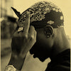 A close-up photo of a person's hand adjusting a bandana while wearing a wristwatch.