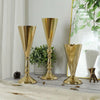 Three elegant golden silver wedding flower vases displayed on a light wooden surface.