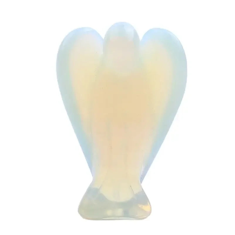 Hand-carved crystal figurine shaped like an angel with a pale blue translucent glow.