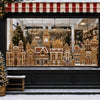 A display of intricate gingerbread houses and festive decorations visible through a large window.