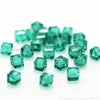 A pile of square cut green glass crystal beads for jewelry making