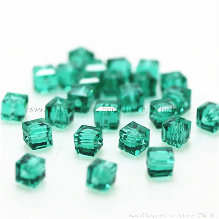 A pile of square cut green glass crystal beads for jewelry making