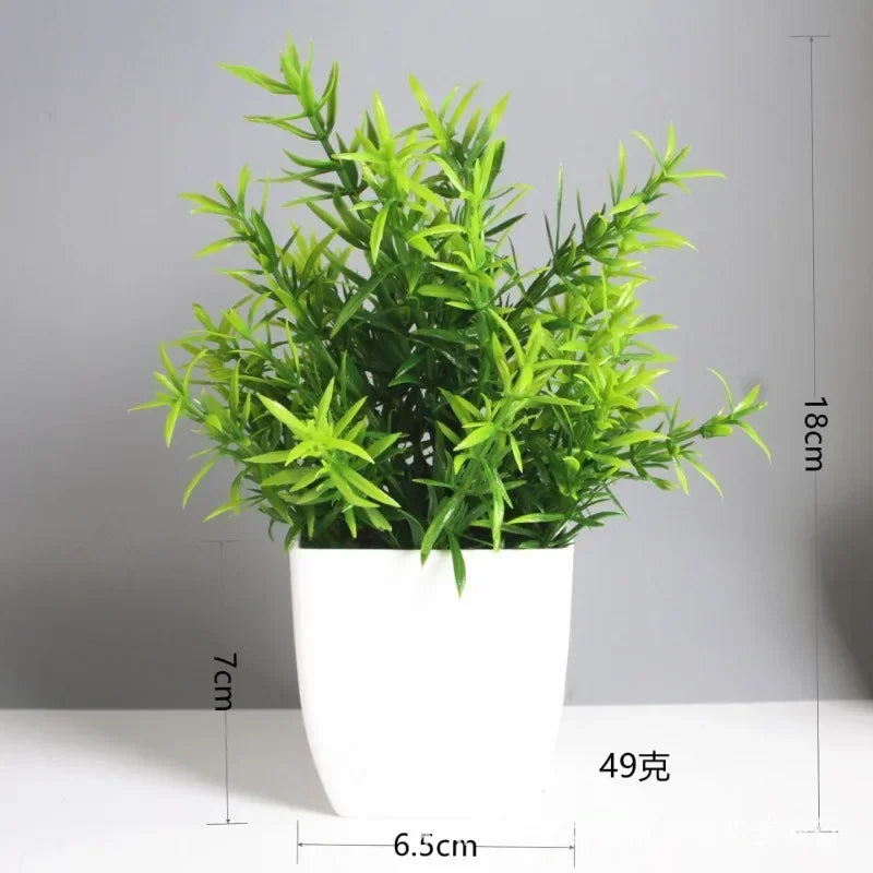 A potted artificial bonsai plant with bright green leaves and eucalyptus accents in a white cylindrical pot.