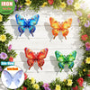 Set of four vibrant metal butterfly wall art decor in various colors and angles displayed on a wooden surface surrounded by g