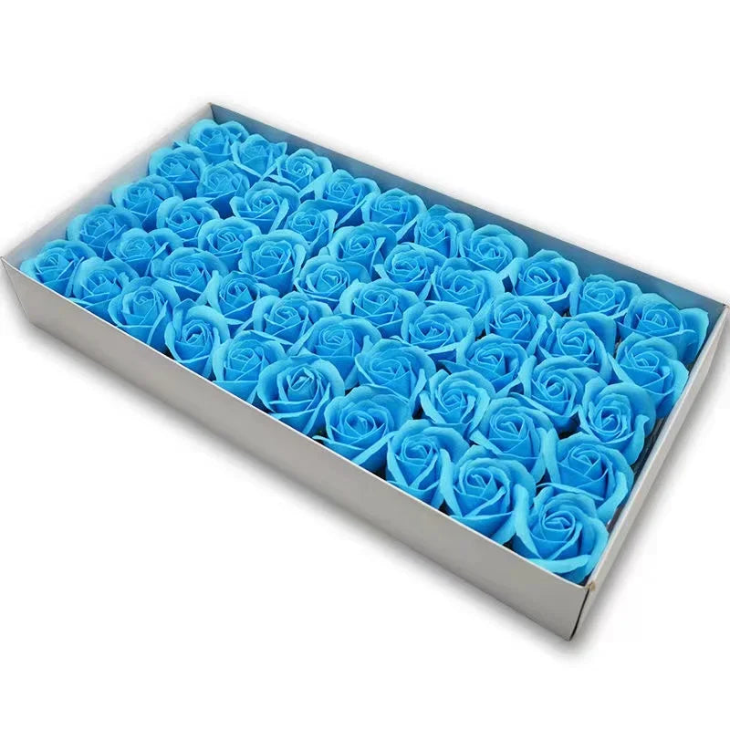 A rectangular box filled with numerous blue artificial rose flower heads.