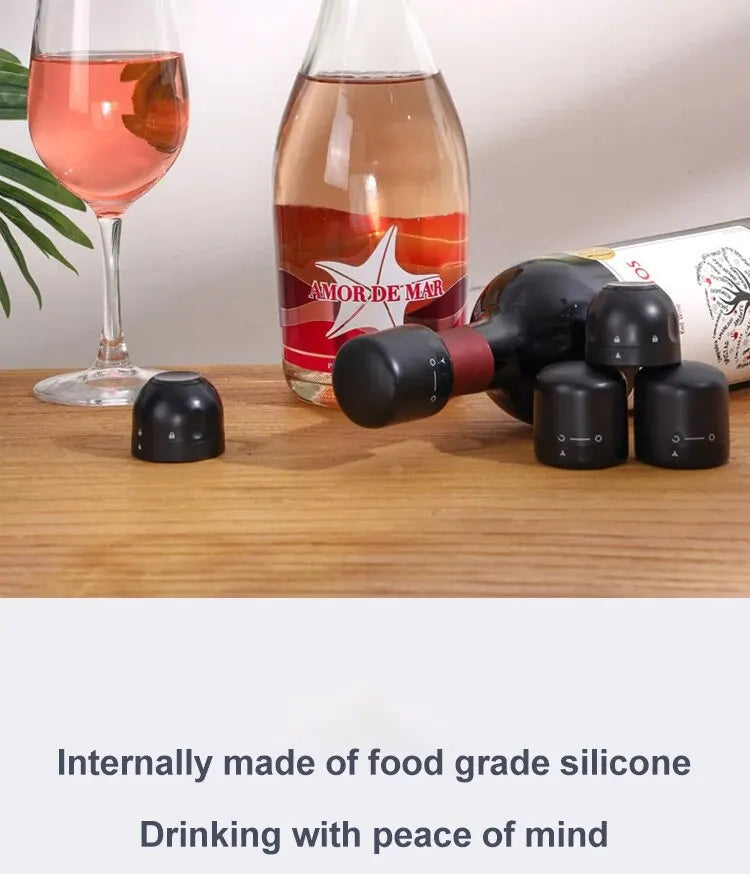 Two black silicone bottle stoppers are shown next to a glass of rosé wine and a glass bottle.