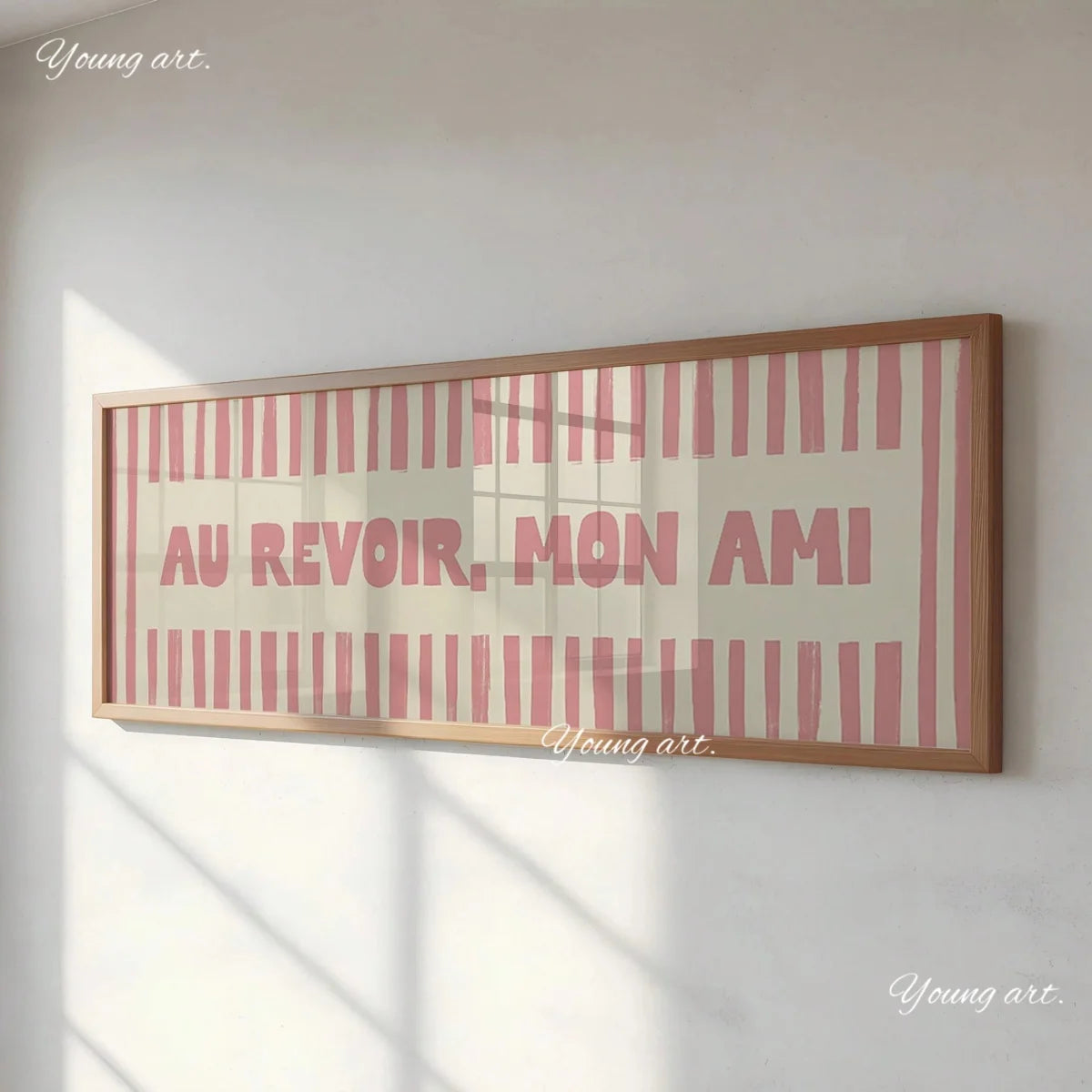 A framed canvas print featuring the text AU REVOIR MON AMI in pink and white stripes on a light background.