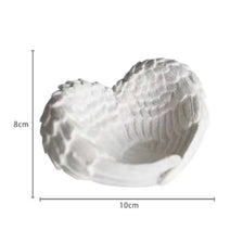 White resin sculpture of an angel wings heart shape for desk and shelf decor