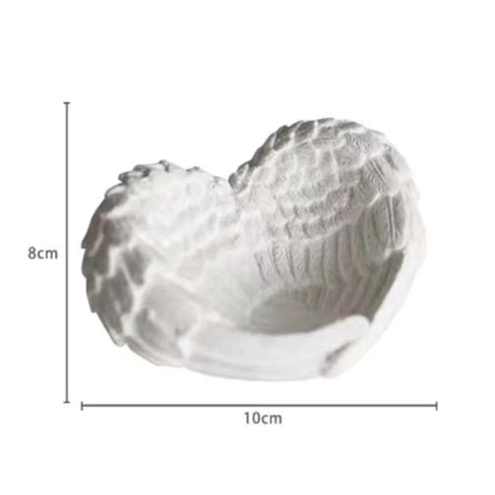White resin sculpture of an angel wings heart shape for desk and shelf decor