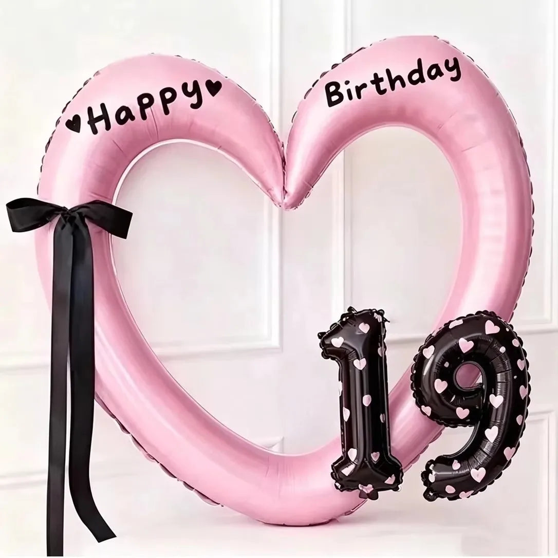 Pink heart-shaped balloon decoration with Happy and Birthday text