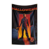 A dark poster featuring a menacing figure in a red shirt standing in a doorway with the text Halloween.