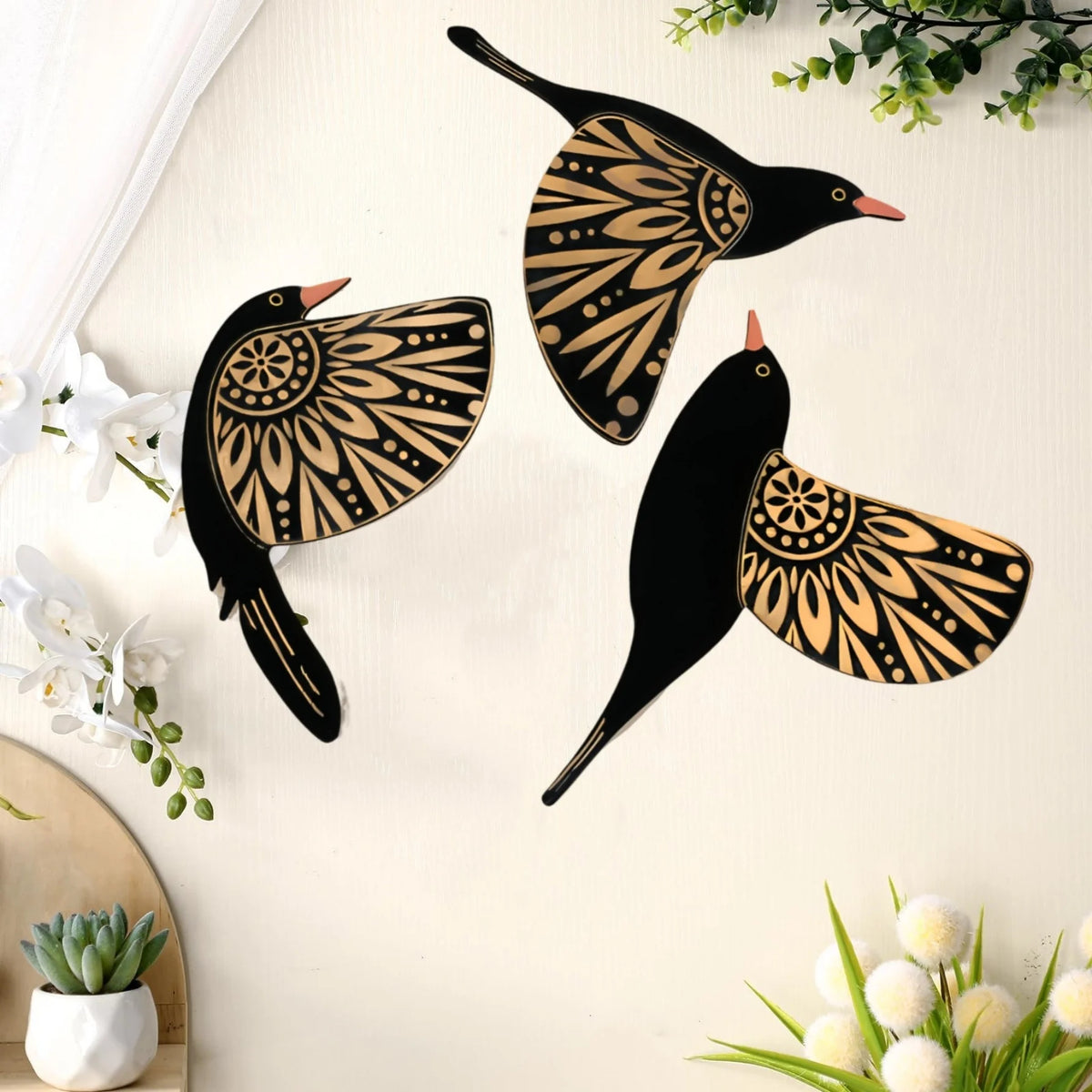 A set of three vintage wooden bird wall decorations featuring intricate patterns in black and tan on a white background.