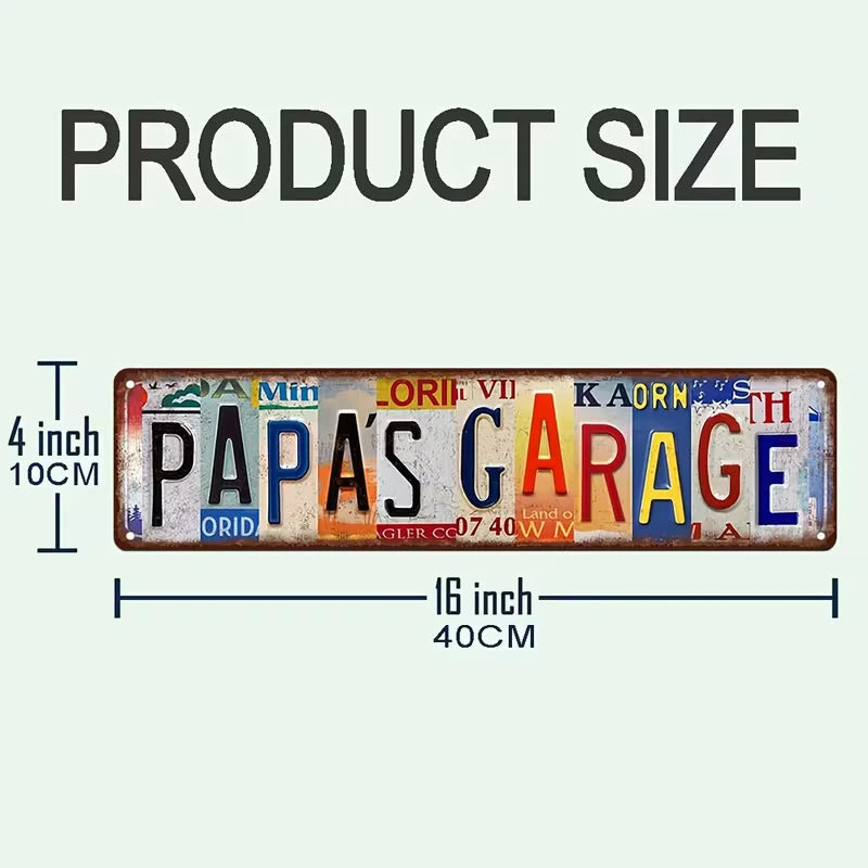 A rectangular vintage metal street sign with the text PAPA'S GARAGE in various colored letters.
