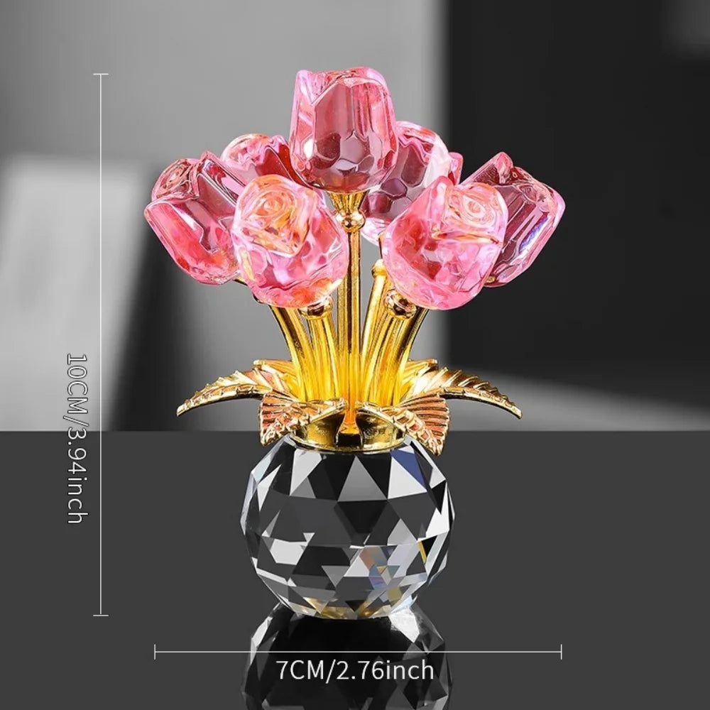 A decorative crystal rose flower arrangement with pink and clear glass petals on a gold stand.