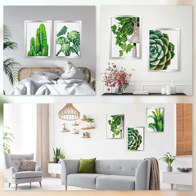 A display of framed diamond art and photos on a white wall, featuring green foliage and floral arrangements.