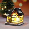 A festive Christmas house night light featuring a dark roof, warm LED glow, and snow accents.