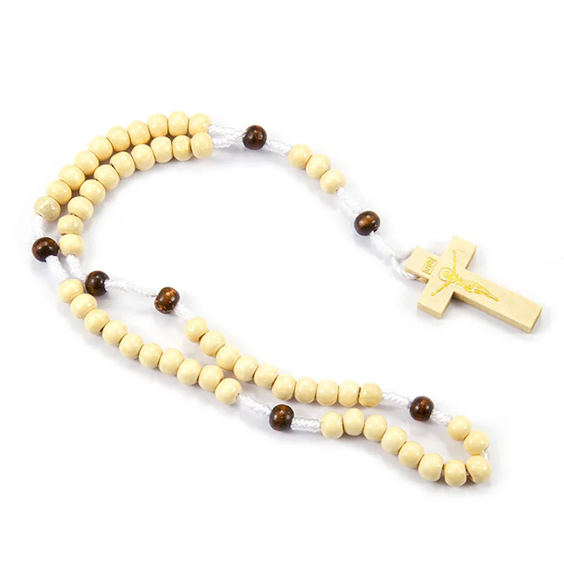 A wooden rosary beads necklace featuring small light wood beads and a gold-colored Jesus crucifix.