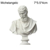 White plaster bust miniature of Michelangelo with a beard and draped clothing on a pedestal.
