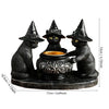 A black Halloween magic cat candle holder featuring three sculpted cats in a row.