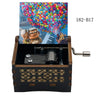 A wooden music box with a lid featuring a colorful fireworks display and a scene of a couple playing music.