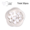 A white silicone heart bead set containing 30 pieces displayed in a small dish.