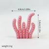 A set of pink ocean animal cake toppers including a whale, octopus, and turtle.