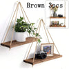 Brown wooden hanging shelf with hemp rope used as a floating wall mount for plants and decor