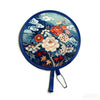 A round, blue fabric fan featuring a floral and cloud design.
