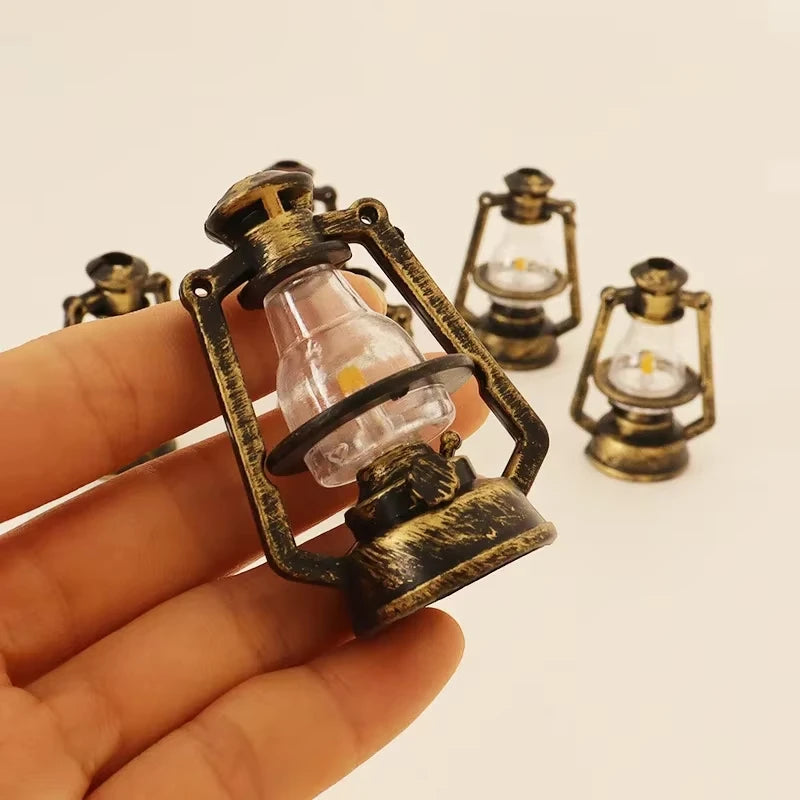 A hand holds a vintage ceramic miniature lantern with a glass bulb and brass-colored metalwork.