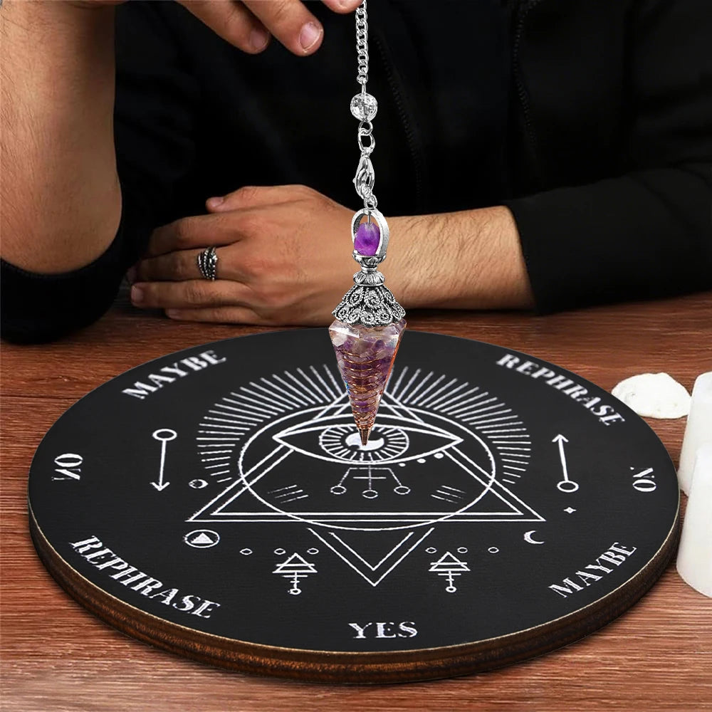 A crystal pendulum set resting on a wooden divination board with various symbols and text.