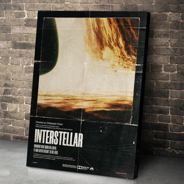 A framed canvas print titled INTERSTELLAR featuring a dramatic orange and brown sky over a horizon.