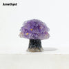 A natural amethyst crystal sculpture shaped like a mushroom tree with gold accents.