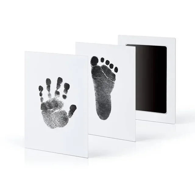 A set of three framed prints showing handprints and footprints on white paper.