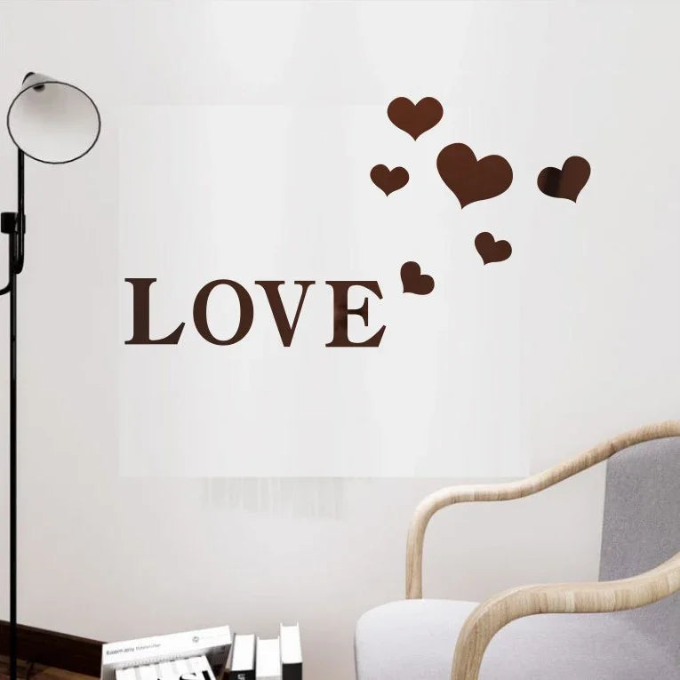 A wall decal featuring the word LOVE in large letters with small brown heart shapes floating above it.