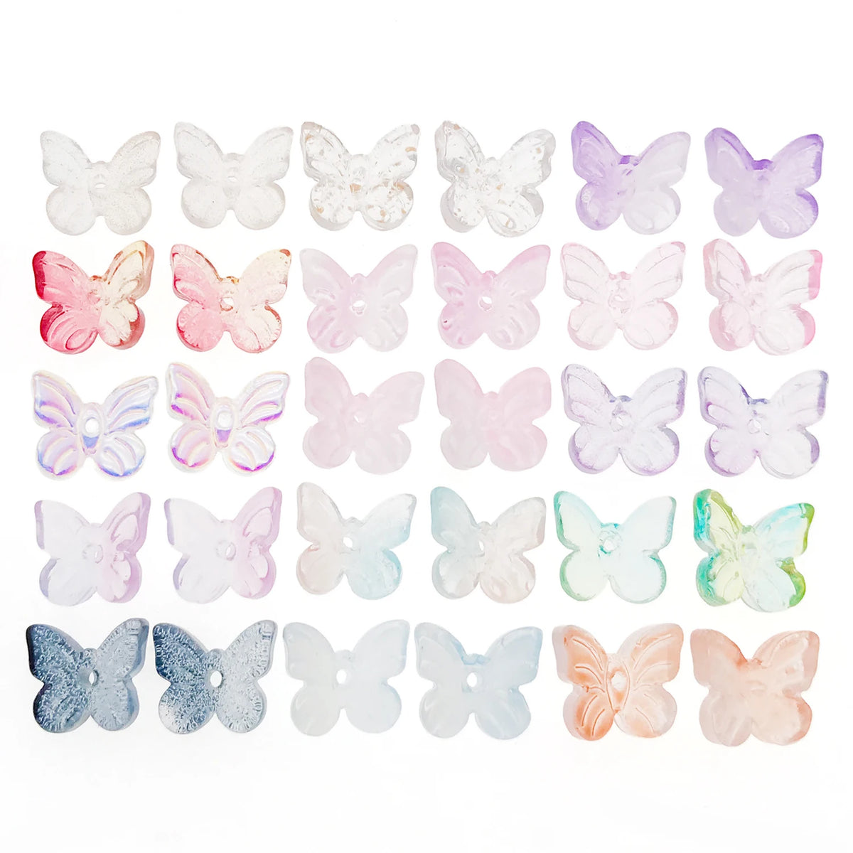 Variedad de cuentas de mariposa de vidrio de colores en varios tonos pastel