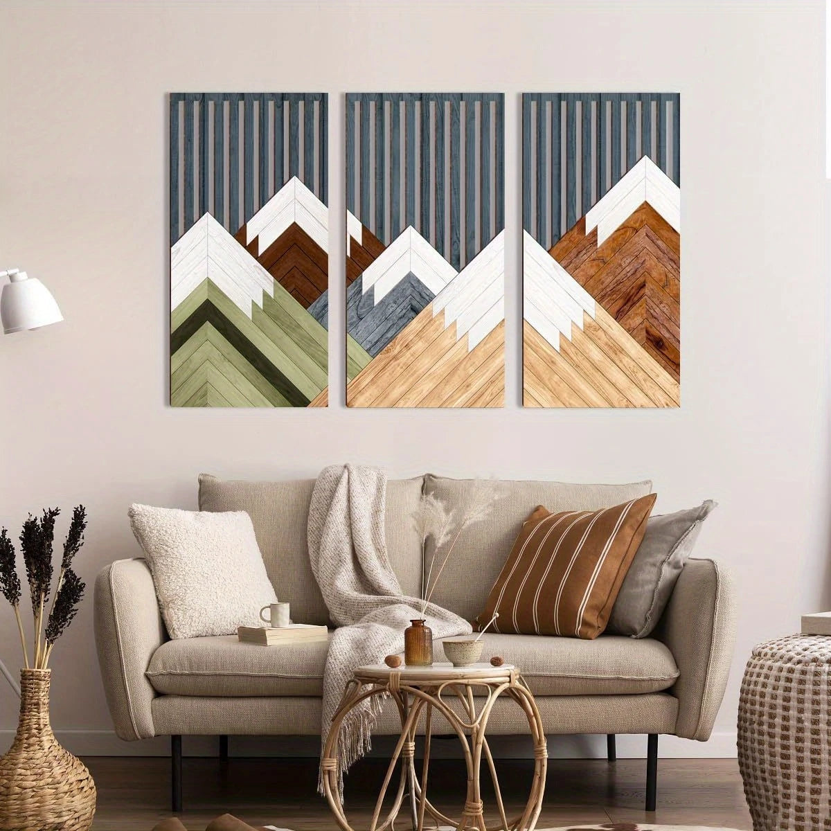 A set of three vertical wall art prints featuring mountains in muted earth tones and white against a gray background.