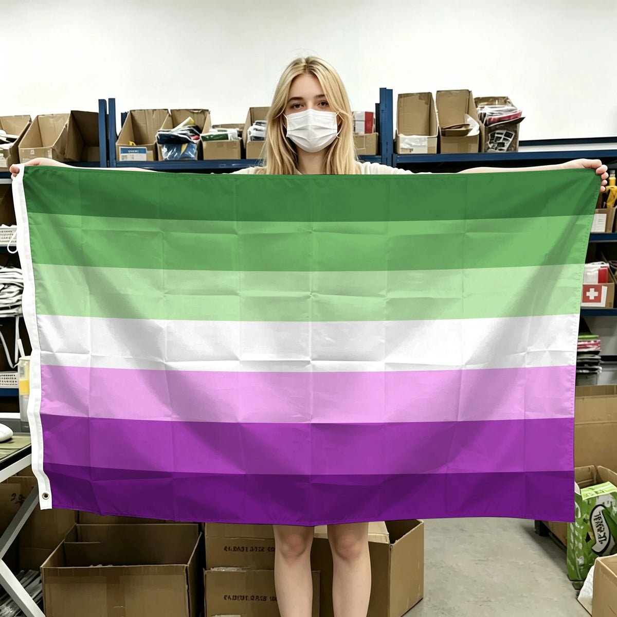 A person holds up a horizontal Pride flag with six horizontal stripes of green, white, and purple.