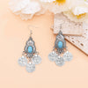 Boucles d'oreilles pendantes en pièce de monnaie turquoise bohème argentées avec des détails de filigrane complexes