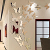 A gallery wall featuring a collection of light brown and beige butterfly-shaped mirror effect stickers mounted on a white wal