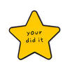 A yellow star enamel pin with the text your did it on it.